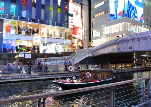 OSAKA, JAPAN - OCT 23: People visit famous Dotonbori canal on October 23, 2012 in Osaka, Japan. According to Tripadvisor Dotonbori is the 3rd best attraction to visit in Osaka.