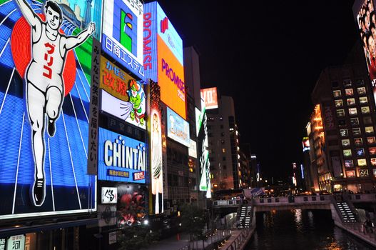 OSAKA, JAPAN - OCT 23: The Glico Man Running billboard and other neon displays on October 23, 2010 in Dotonbori, Osaka, Japan. Dotonbori has many shops, restaurants and colorful billboards. 