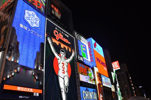 OSAKA, JAPAN - OCT 23: The Glico Man Running billboard and other neon displays on October 23, 2010 in Dotonbori, Osaka, Japan. Dotonbori has many shops, restaurants and colorful billboards. 