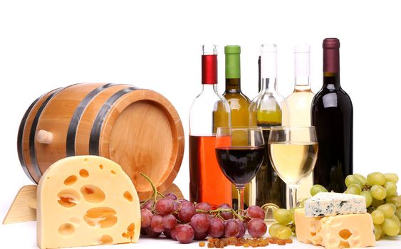 barrel, cheeses, bottles and glasses of wine and ripe grapes on wooden