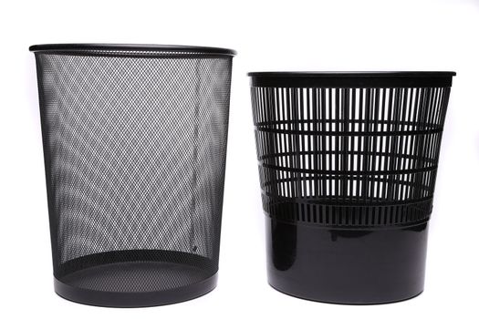 Metal and plastic trash cans on white background