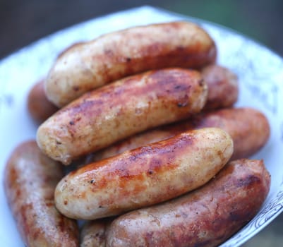 Pork sausages barbecued on the plate