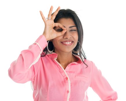 Indian businesswoman focused by hand hole. Portrait of beautiful Asian female model standing isolated on white background.