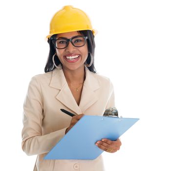 Smiling Indian female construction engineer with safety helmet smiling happy writing report. Portrait of beautiful Asian female model standing isolated on white background.