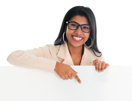 Indian woman holding and pointing to blank billboard. Portrait of attractive young Asian female model isolated on white background.