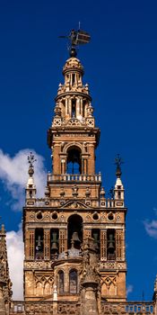 Giralda Spire, Bell Tower, Seville Cathedral, Cathedral of Saint Mary of the See, Seville, Andalusia Spain.  Built in the 1500s.  Largest Gothic Cathedral in the World and Third Largest Church in the World.  Burial Place of Christopher Columbus.  Giralda is a former minaret converted into a bell tower