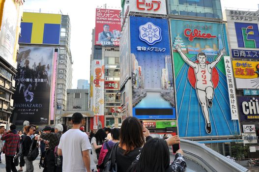 OSAKA, JAPAN - OCT 23: People visit famous Dotonbori street on October 23, 2012 in Osaka, Japan. According to Tripadvisor Dotonbori is the 3rd best attraction to visit in Osaka. 