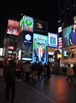 OSAKA, JAPAN - OCT 23: The Glico Man Running billboard and other neon displays on October 23, 2010 in Dotonbori, Osaka, Japan. Dotonbori has many shops, restaurants and colorful billboards. 