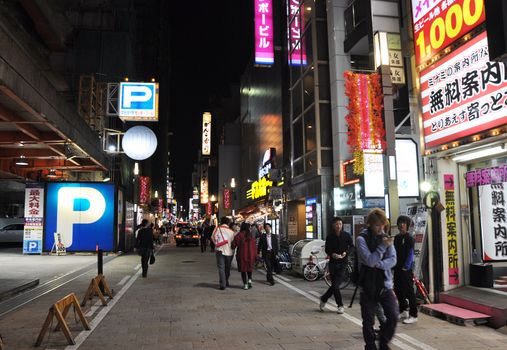 OSAKA, JAPAN - OCT 23: People visit famous Dotonbori street on October 23, 2012 in Osaka, Japan. According to Tripadvisor Dotonbori is the 3rd best attraction to visit in Osaka. 