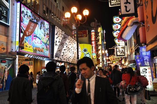 OSAKA, JAPAN - OCT 23: People visit famous Dotonbori street on October 23, 2012 in Osaka, Japan. According to Tripadvisor Dotonbori is the 3rd best attraction to visit in Osaka. 