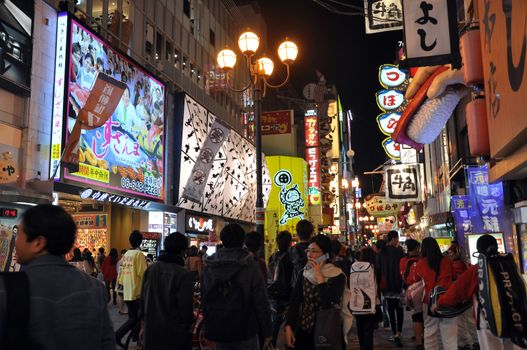 OSAKA, JAPAN - OCT 23: People visit famous Dotonbori street on October 23, 2012 in Osaka, Japan. According to Tripadvisor Dotonbori is the 3rd best attraction to visit in Osaka. 