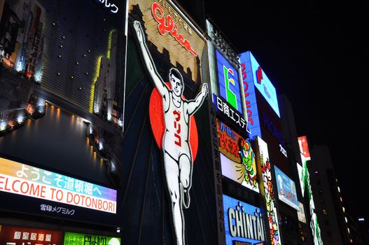 OSAKA, JAPAN - OCT 23: The Glico Man Running billboard and other neon displays on October 23, 2010 in Dotonbori, Osaka, Japan. Dotonbori has many shops, restaurants and colorful billboards. 