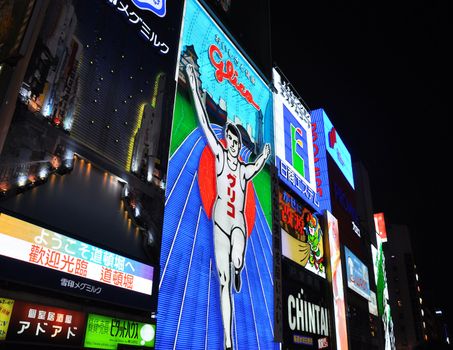 OSAKA, JAPAN - OCT 23: The Glico Man Running billboard and other neon displays on October 23, 2010 in Dotonbori, Osaka, Japan. Dotonbori has many shops, restaurants and colorful billboards. 