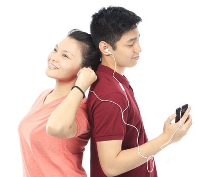 Young teenagers listening to music together