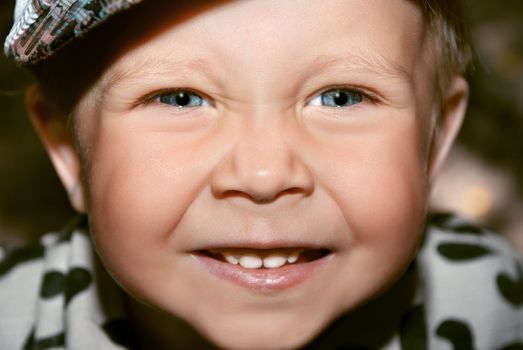 Beautiful and cheerful boy. Close-up portrait.