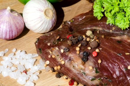 meat with fresh vegetables on wooden board