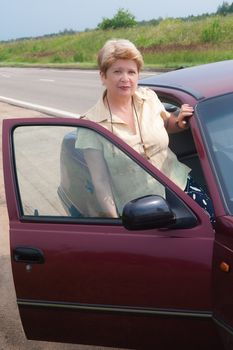 A woman sits in the car