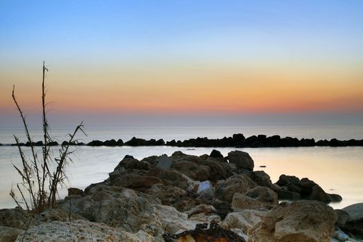 Sunrise over the Adriatic Sea, Italy.
The rising sun touches the rocks and creates a nice reflection on the water.