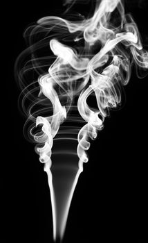 Abstract white smoke swirls over black background