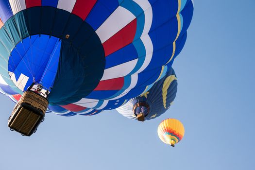 Colorful hot air balloons in flight over wine country at the Temecula Balloon and Wine Festival