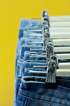Row of hanged blue jeans in a shop