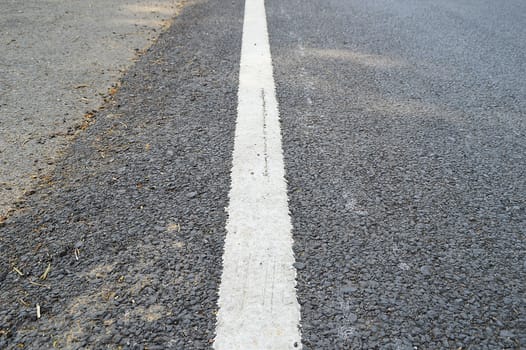Close up road divide white line on asphalt road