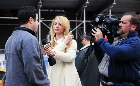 NEW YORK CITY - MAY 16: Journalists Fox Business News interview on Times Square May 16, 2013 in Manhattan, New York City