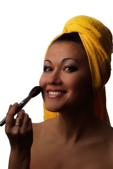 Photo of smiling model with cosmetic brush for skin care