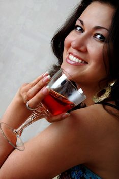 Close-up portrait of the smiling lady with wineglass