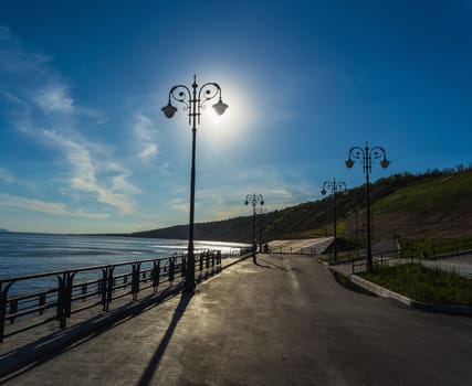 Street lights on the promenade on the shore of the great river