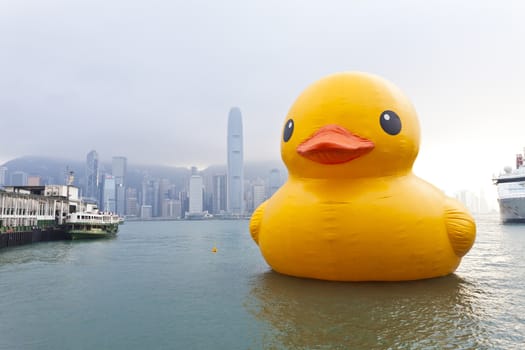 HONG KONG - MAY 6: The rubber duck swim in Victoria Harbour on May 6 2013. Giant 'Rubber Duck' Sculpture By Artist Florentijn Hofman, visit Hong Kong which draw the attention of local.