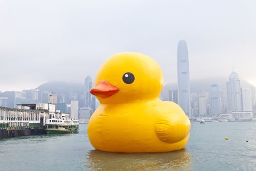 HONG KONG - MAY 6: The rubber duck swim in Victoria Harbour on May 6 2013. Giant 'Rubber Duck' Sculpture By Artist Florentijn Hofman, visit Hong Kong which draw the attention of local.