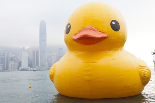 HONG KONG - MAY 6: The rubber duck swim in Victoria Harbour on May 6 2013. Giant 'Rubber Duck' Sculpture By Artist Florentijn Hofman, visit Hong Kong which draw the attention of local.