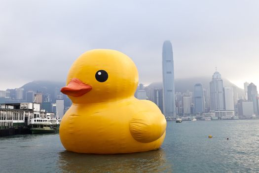 HONG KONG - MAY 6: The rubber duck swim in Victoria Harbour on May 6 2013. Giant 'Rubber Duck' Sculpture By Artist Florentijn Hofman, visit Hong Kong which draw the attention of local.