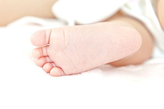 A close-up of tiny baby feet