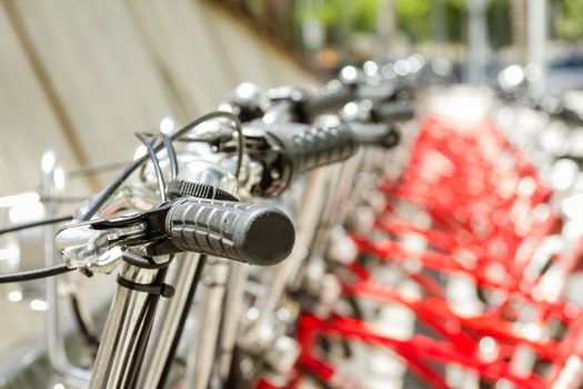Red bicycles parked in a row on the street, in Barcelona, Spain