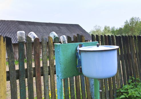 Rustic courtyard and home-made basin on the fence