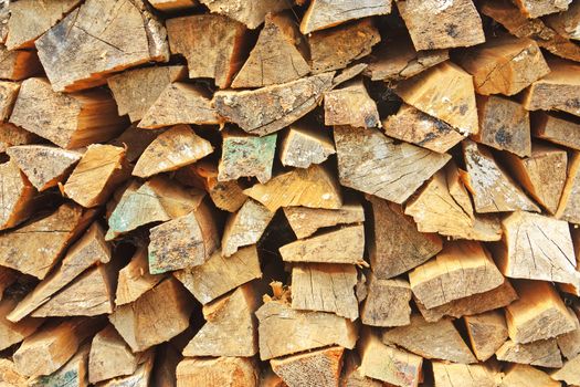 Stack of firewood neatly stacked close-up background