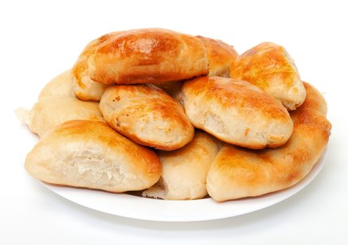 Heap baked patties on plate, white background