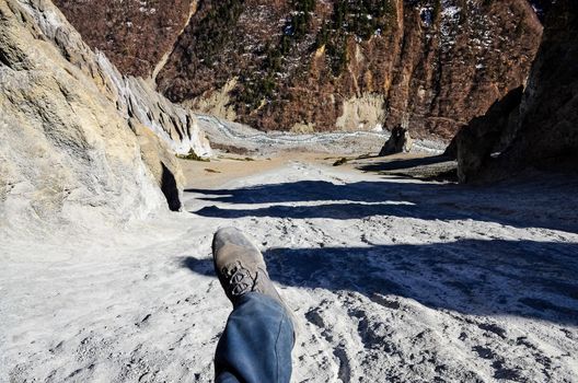 Feet in the air above dangerous mountain cliff