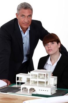 Architects posing with a building model