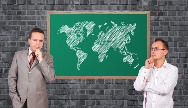 two businessman and world map on blackboard