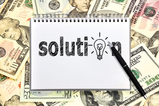 notebook with solution on money background