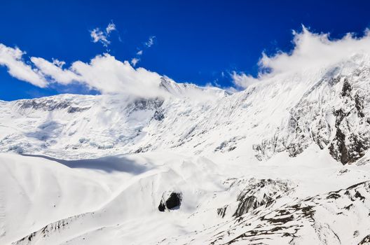 Snow mountain peak with clouds and blue sky, Himalayas, Nepal