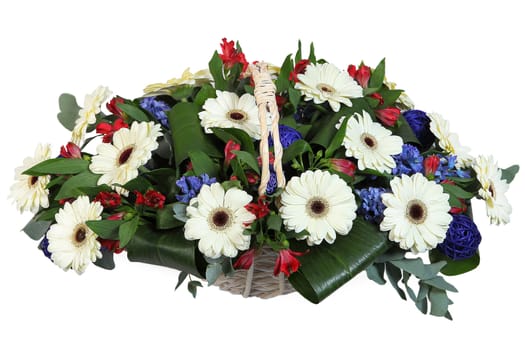 White flowers and dark green leaves in a basket, white gerbera. Flowers Arrangement of white, red and blue flowers.
