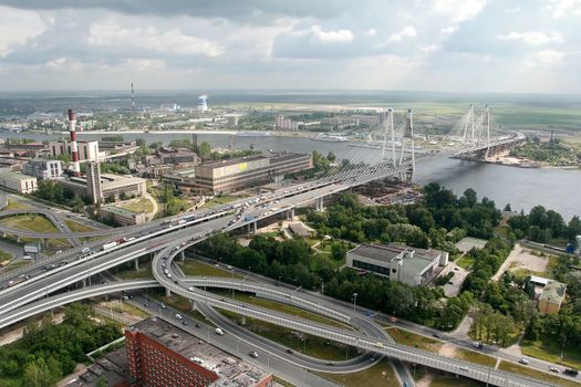  ST-PETERSBURG, RUSSIA - JULY 19: Road interchange Ring Road and Avenue Obukhovskoy Oborony, before the bridge Bolshoi Obuhovsky. The Russian Federation, St. Petersburg, July 19, 2007. The bridge is under construction the second part. Under the bridge the river Neva. Taking pictures is made from a helicopter. Editorial image.