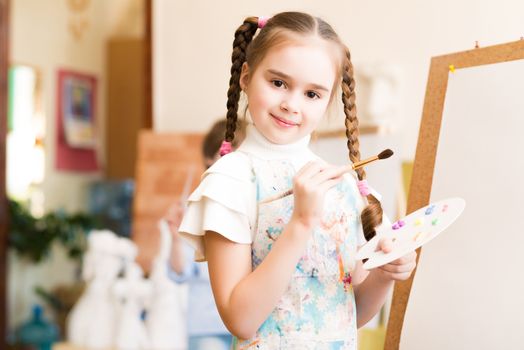 portrait of a girl standing next to his easel, a drawing lesson