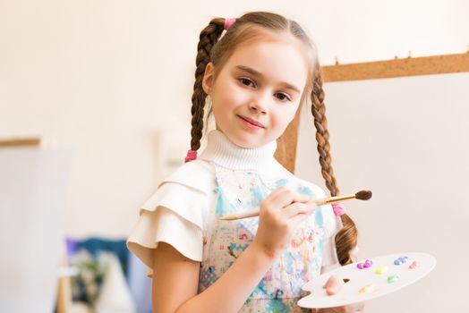 portrait of a girl standing next to his easel, a drawing lesson