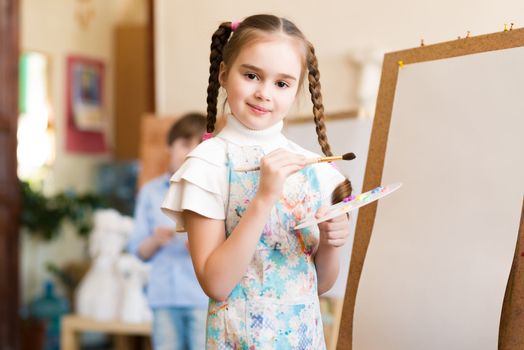 portrait of a girl standing next to his easel, a drawing lesson