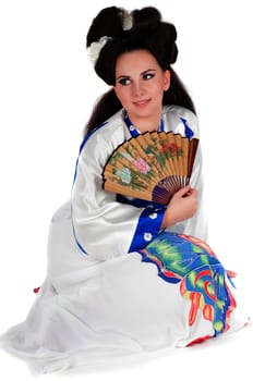 Geisha sitting on the floor, isolated on white